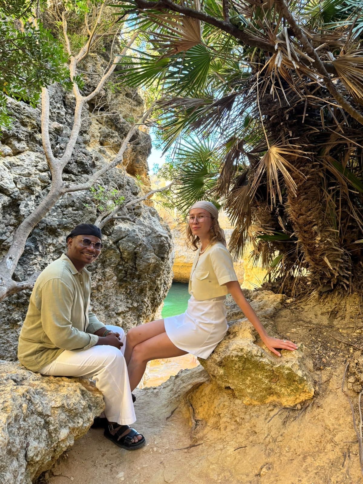 A couple photographed on the rocks above a cove on the tour